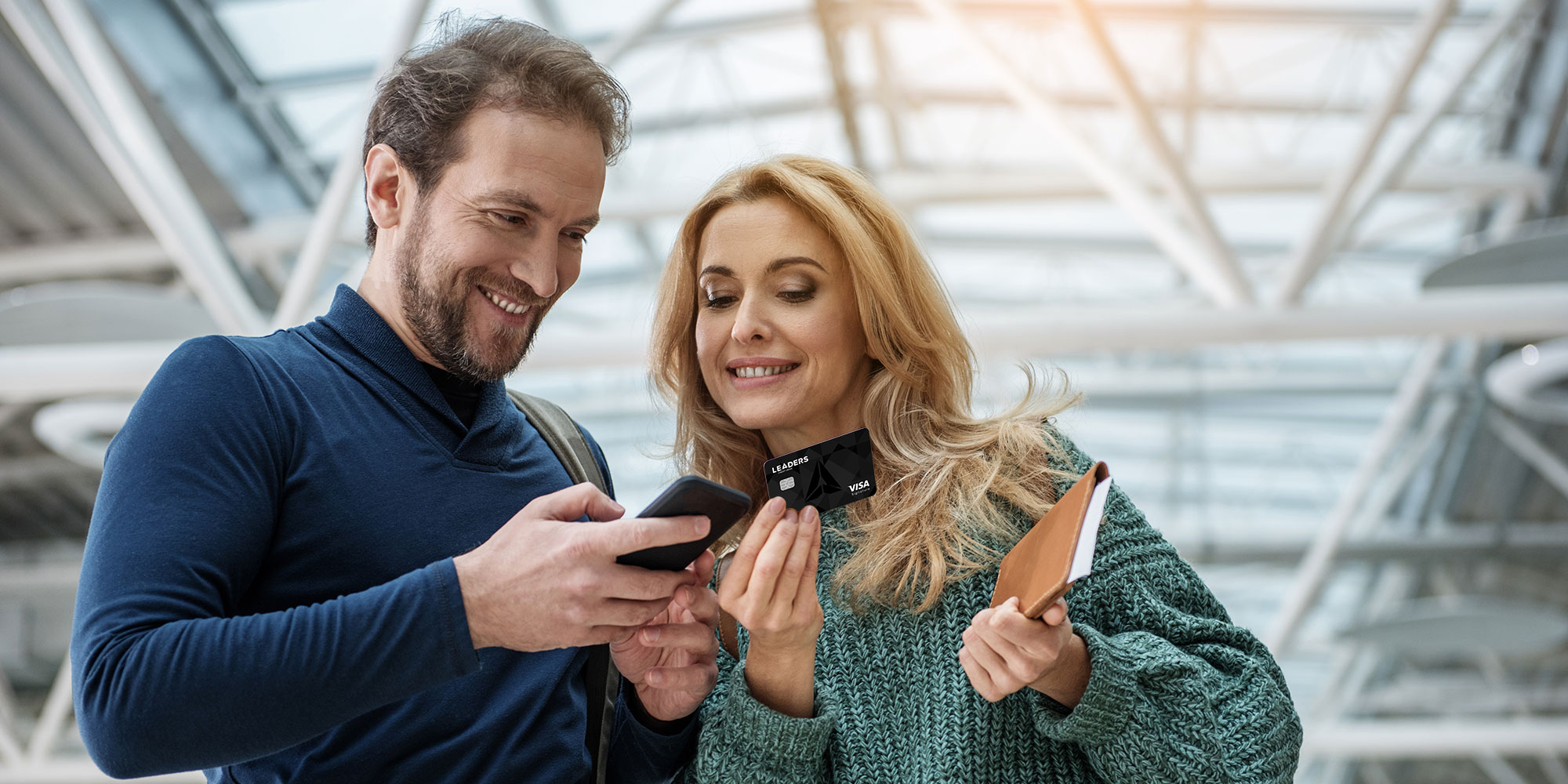 man and woman traveling with credit card