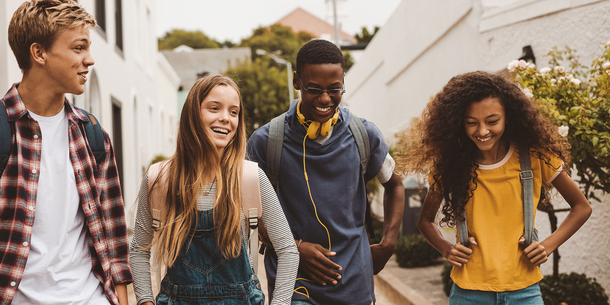 Group of gen z young adults walking together.