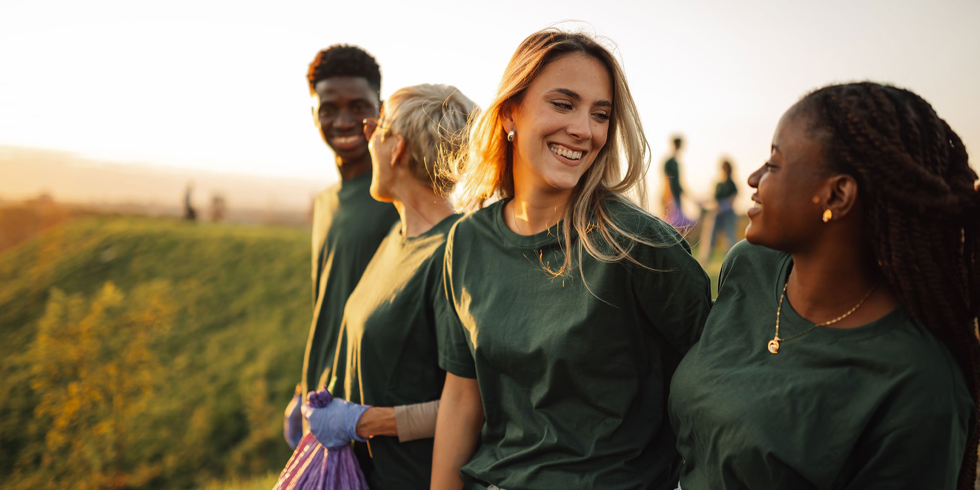 Group of volunteers smiling at each other. 