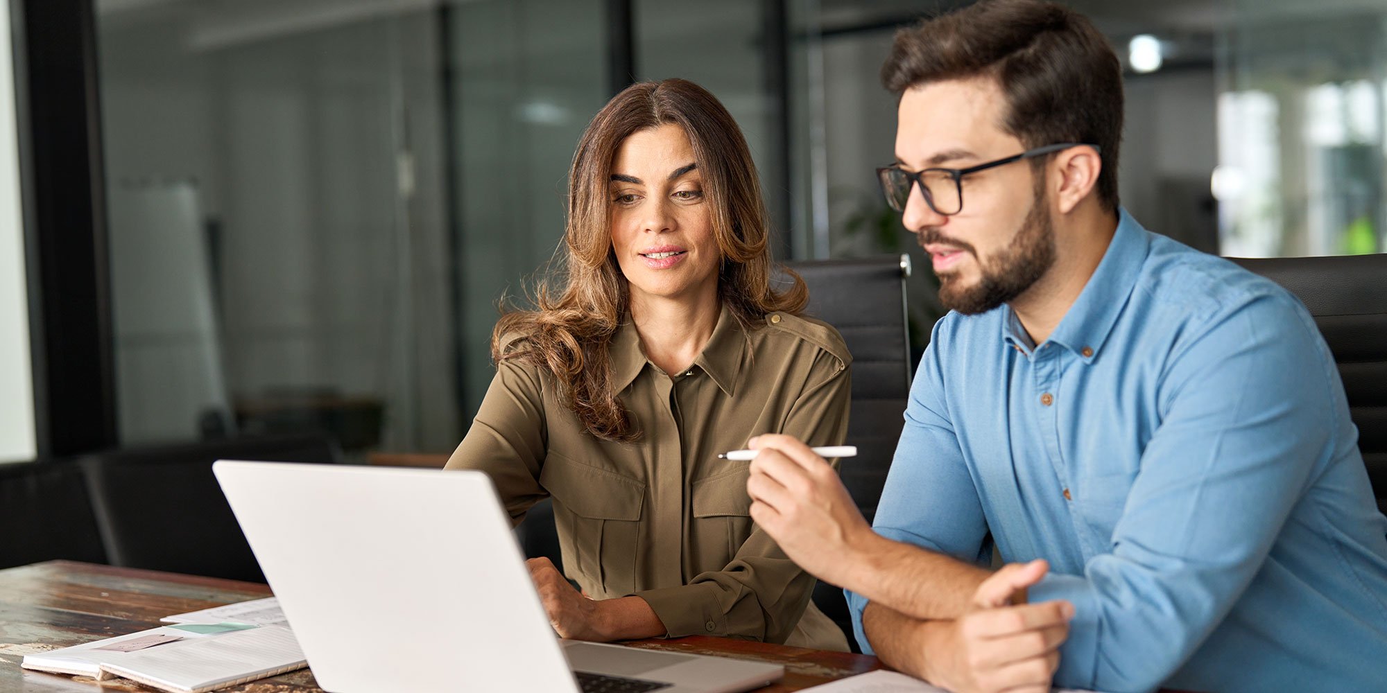 Man and woman looking at their finances on a laptop.